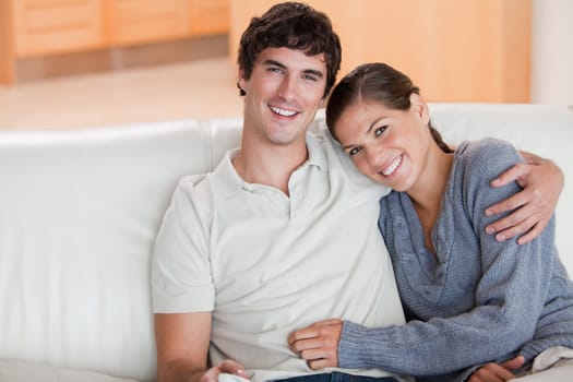 Happy young couple enjoying their time together on the couch