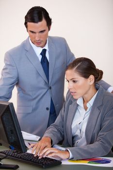 Young businesswoman showing screen to her colleague