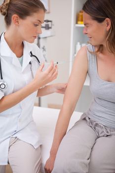 Patient receiving painful injection from doctor