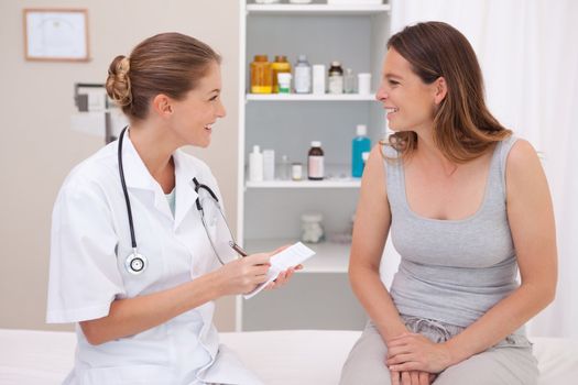 Smiling doctor with patient in examination room