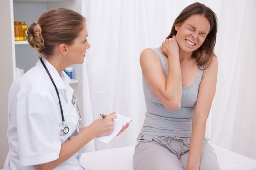 Patient next to doctor having painful shoulder