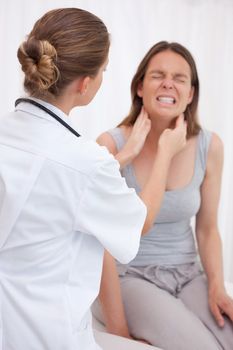 Doctor examining patients painful jaw