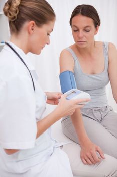 Doctor measuring patients blood pressure