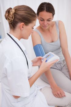Doctor and patient measuring blood pressure together