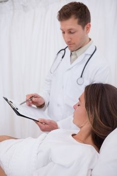 Doctor explaining his bedridden patient the examination results