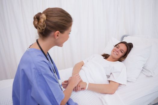 Surgeon visiting her bedridden patient