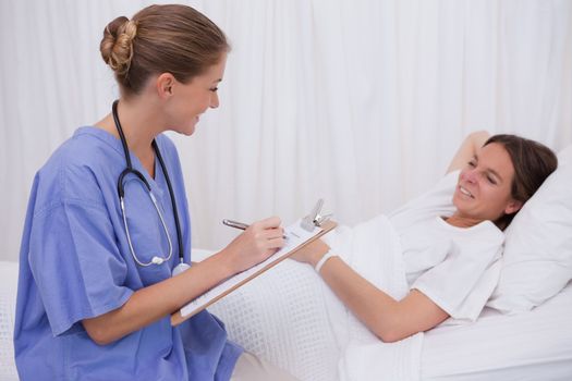Surgeon questioning bedridden patient
