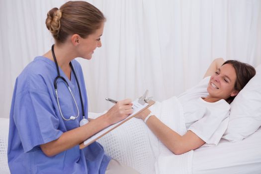 Surgeon talking with bedridden patient