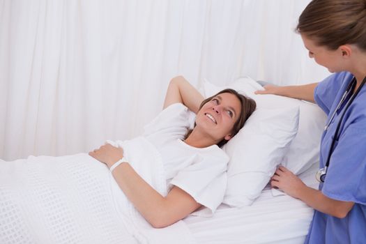 Surgeon plumping up pillow for patient