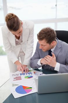 Businesswoman explaining research results to colleague