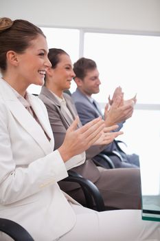 Business team applauding after listening to presentation