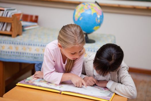 Schoolgirls reading a fairy tale in a classroom