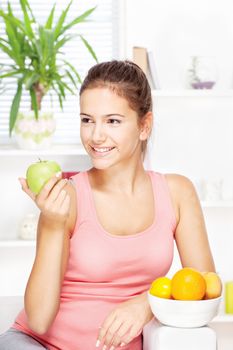 young happy woman at home with fruits