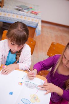 Portrait of a schoolgirls drawing in a classroom