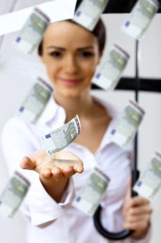 Collage with business woman under money rain with umbrella