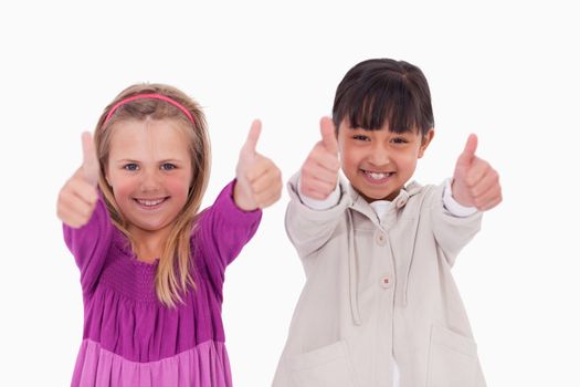 Girls with the thumbs up against a white background