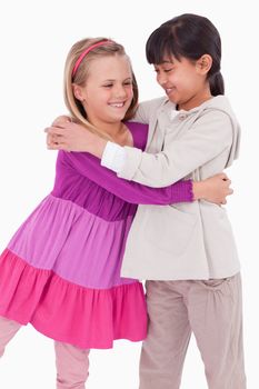 Portrait of girls hugging against a white background