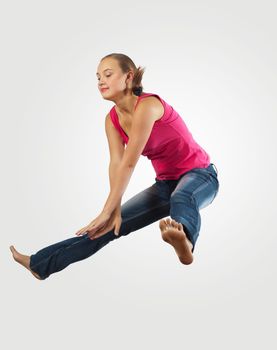 young woman playing on electro guitar and jumping