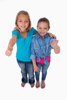 Portrait of girls with the thumbs up against a white background