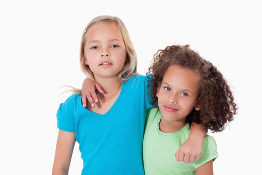 Young friends posing against a white background