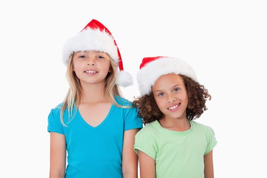 Girls with Christmas hats against a white background