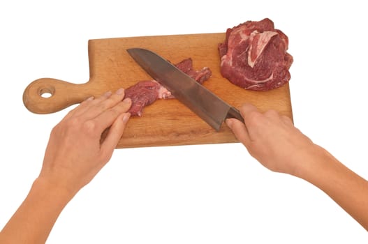 Slices of the meat on the board with knife on the kitchen