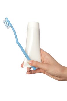 Tooth-paste and brush at in the girl's hand