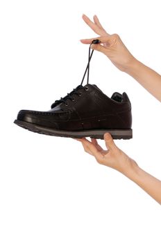 New model of black urban footwear in saleswoman's hands