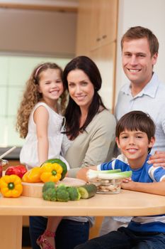 Young family standing in the kitchen together