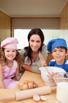 Mother and her children preparing dough together