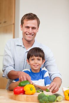 Father and son preparing vegetables together