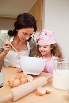 Mother and daughter preparing cookies together