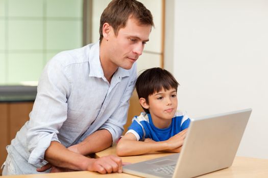 Father and little son looking at laptop