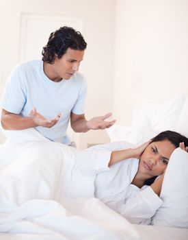 Young couple having quarrel in the bedroom