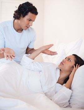 Young couple arguing in the bedroom