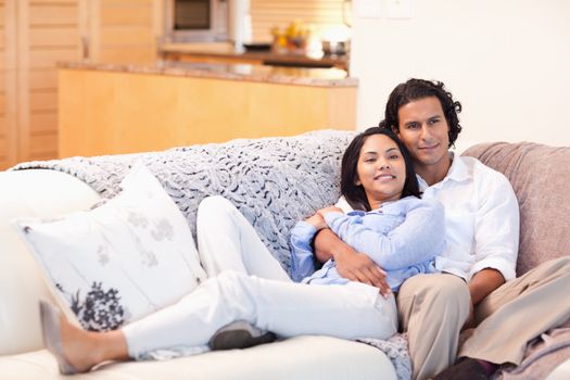 Happy young couple on the couch together