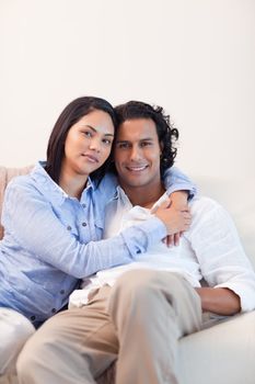 Young couple on the couch embracing
