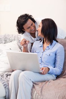 Young couple surfing the internet on the sofa