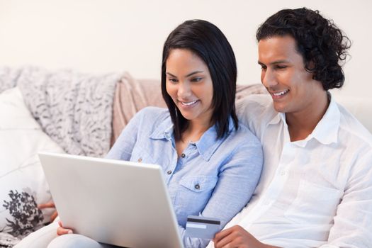 Young couple with laptop on the couch