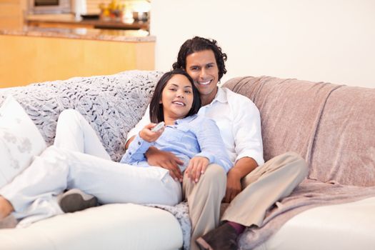 Young couple enjoys watching television together