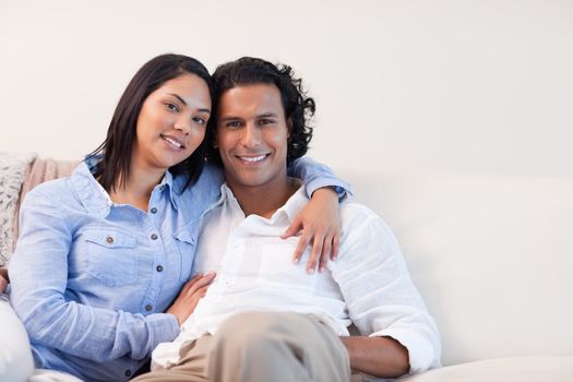 Young couple on the sofa hugging