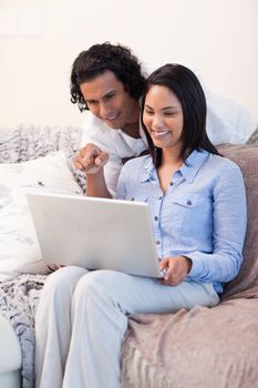 Young couple on the sofa surfing the internet together