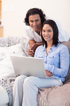 Young couple surfing the internet on the couch