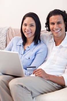 Young couple with notebook on the couch