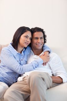 Young couple on the sofa embracing