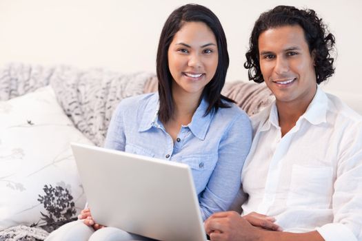 Young couple with laptop on the sofa