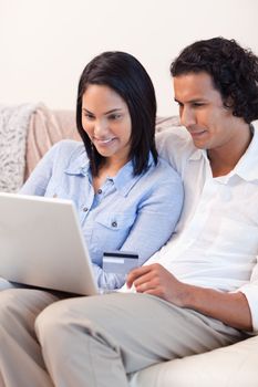 Young couple booking holidays online together