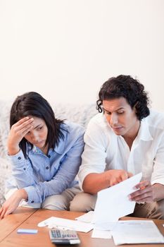 Young couple talking about bad news they got by mail