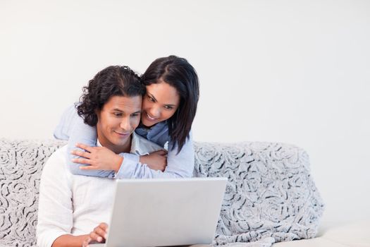 Young couple spending time online in the living room together