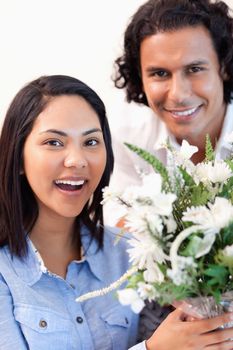 Young woman holding the bouquet she got from her boyfriend